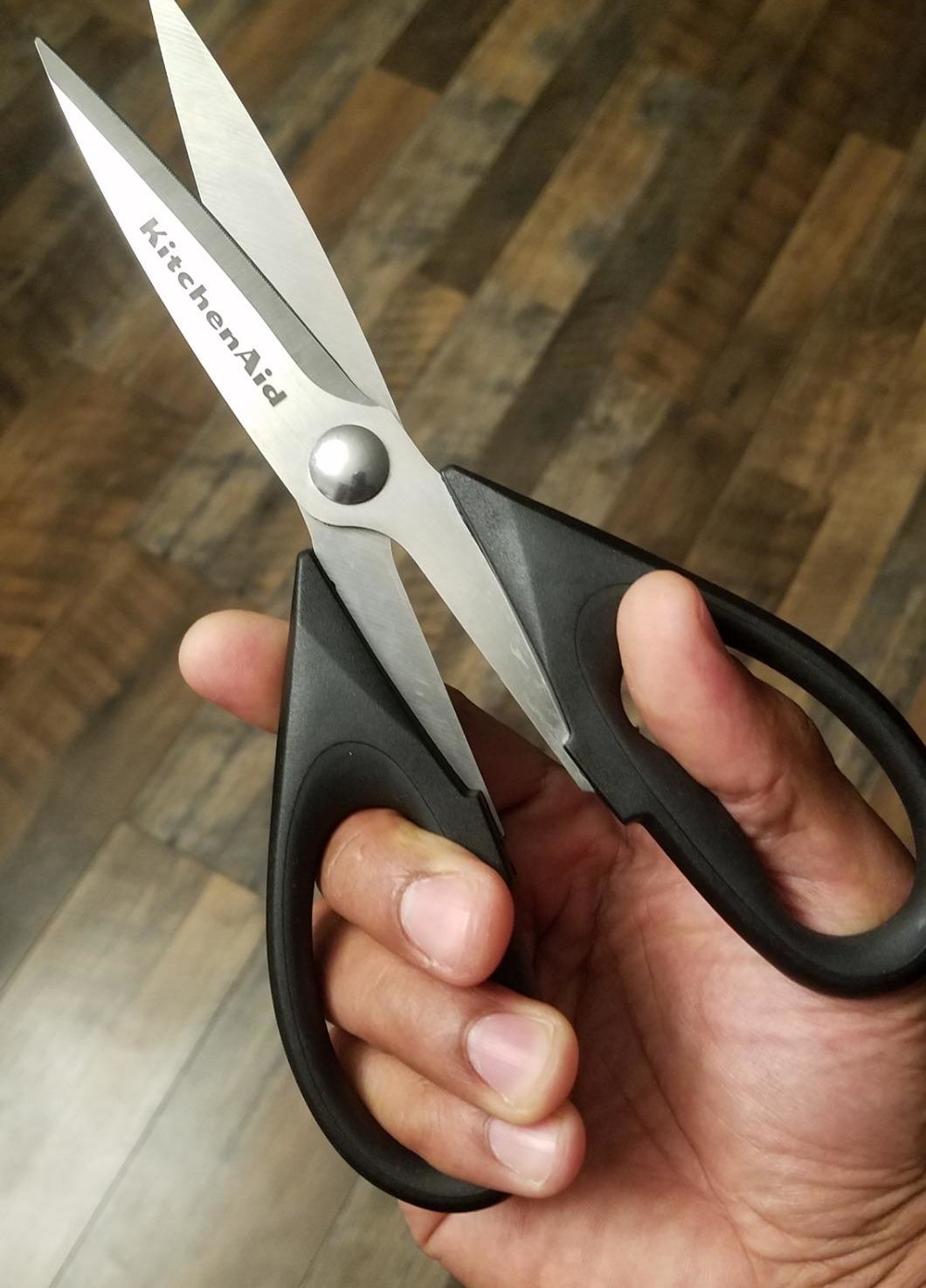 Reviewer&#x27;s photo of them holding the kitchen shears in the color Black