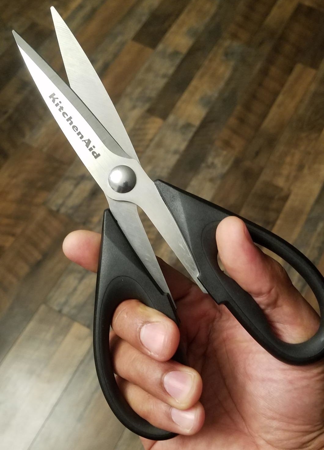 Reviewer's photo of them holding the kitchen shears in the color Black
