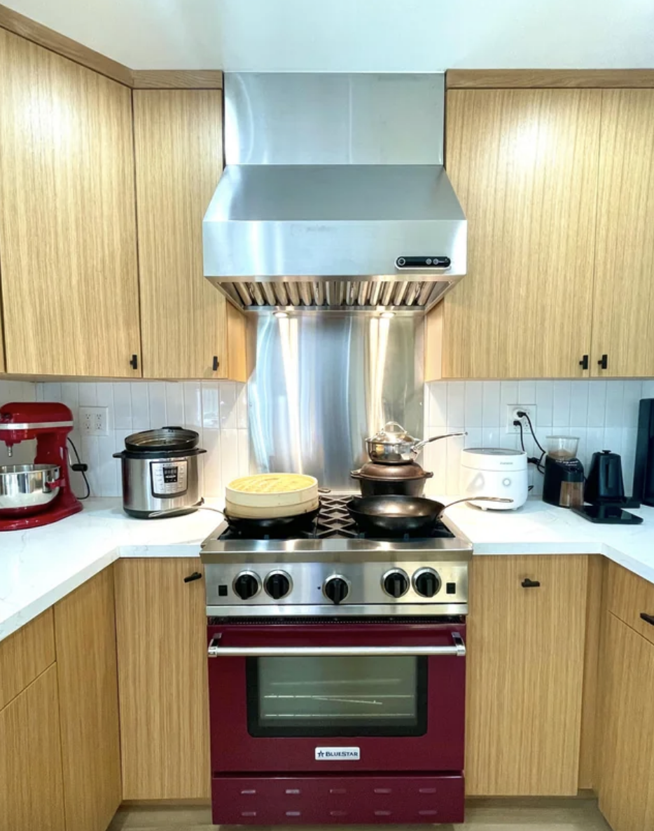 Large stainless steel range hood over a stove in the kitchen