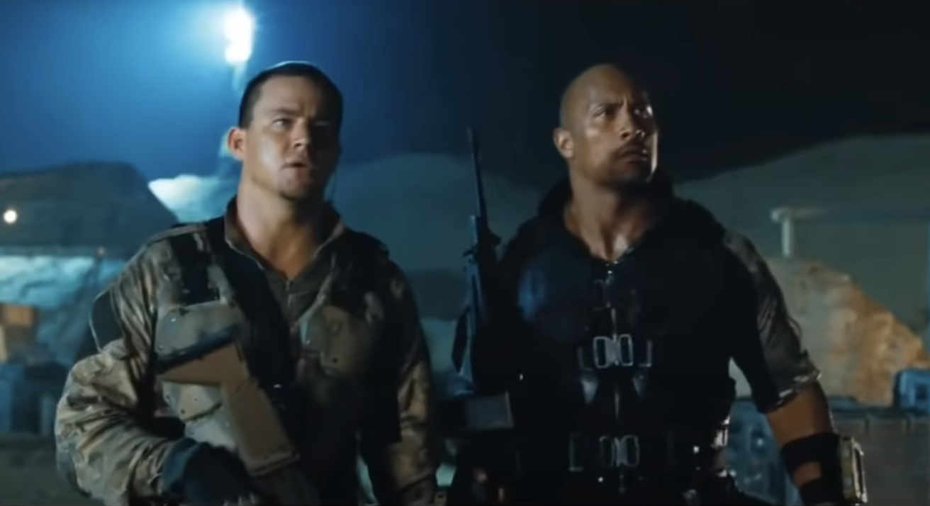 closeup of two characters holding guns in the movie