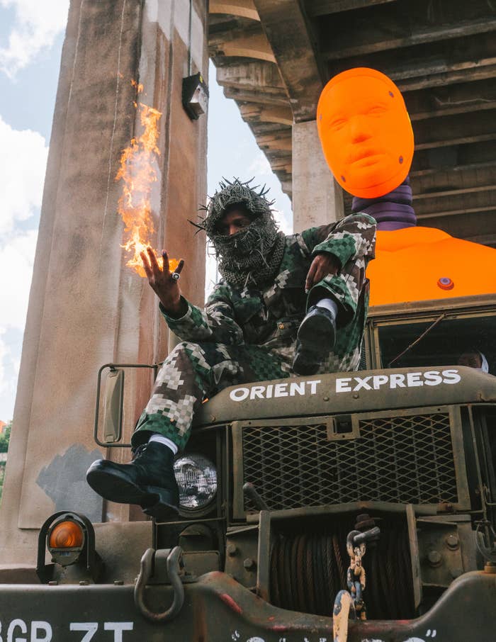 asap rocky is pictured on top of truck