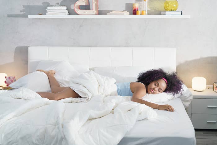 woman sleeps alone and peacefully on a bed