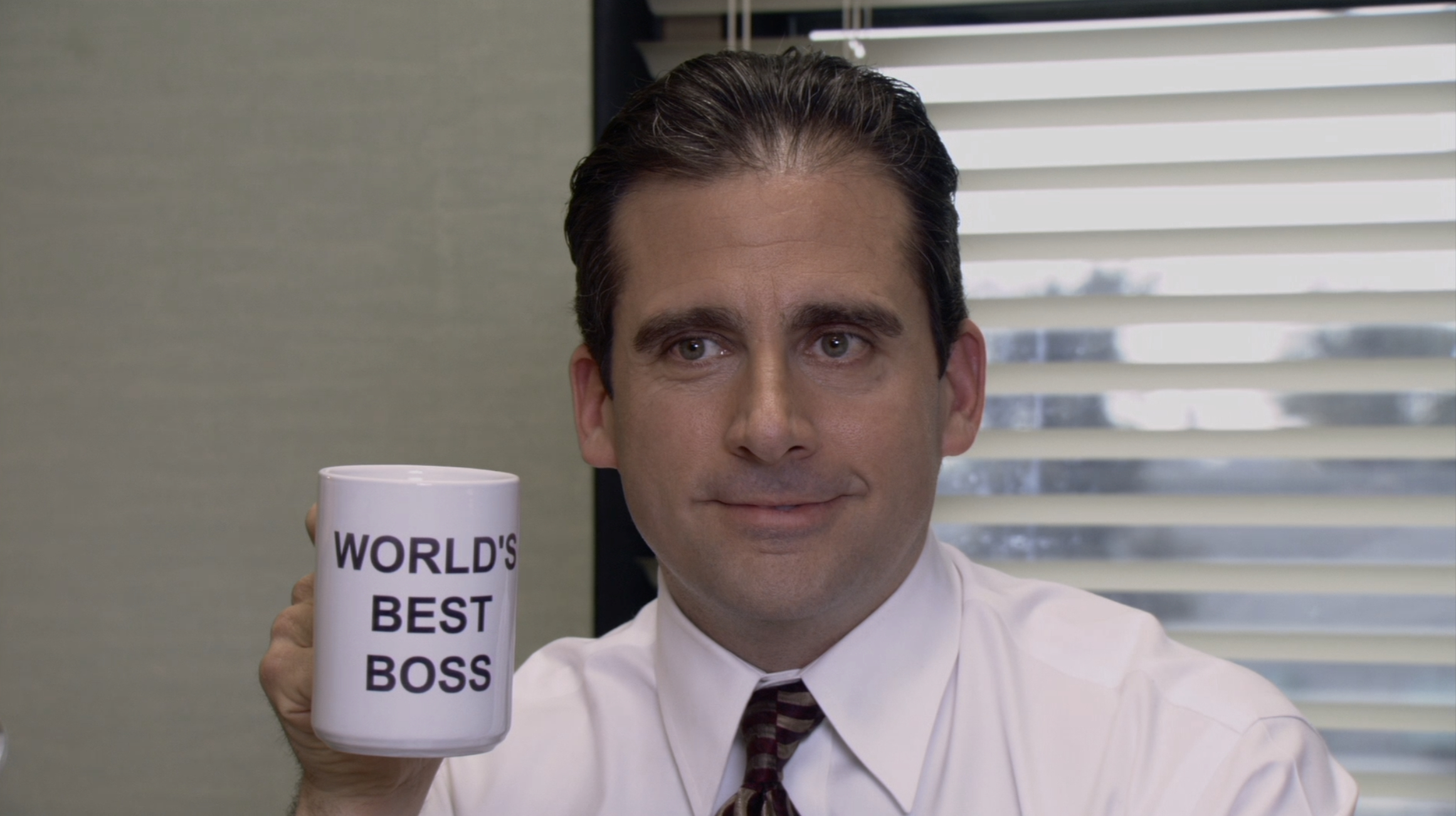 michael holding his world&#x27;s best boss mug on the office