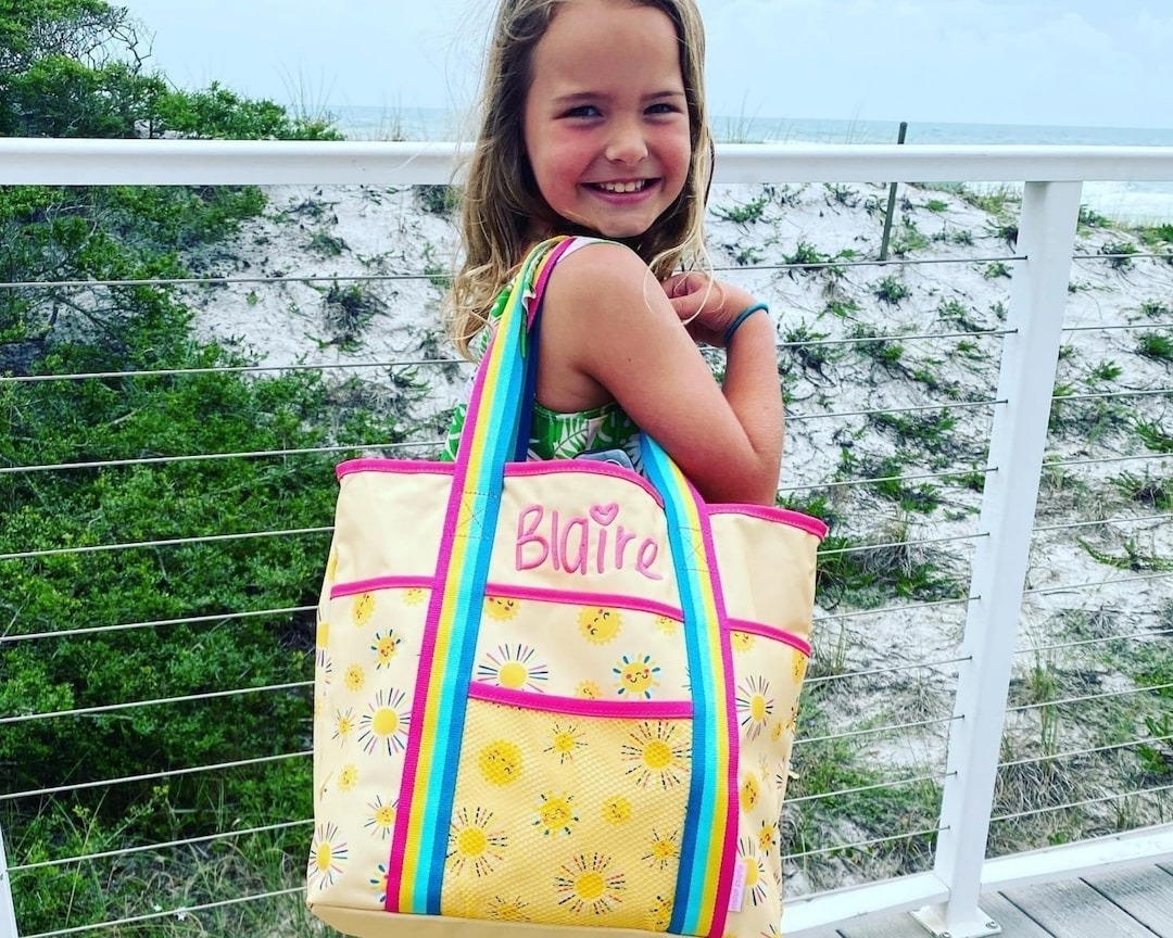 Child carries a personalized tote