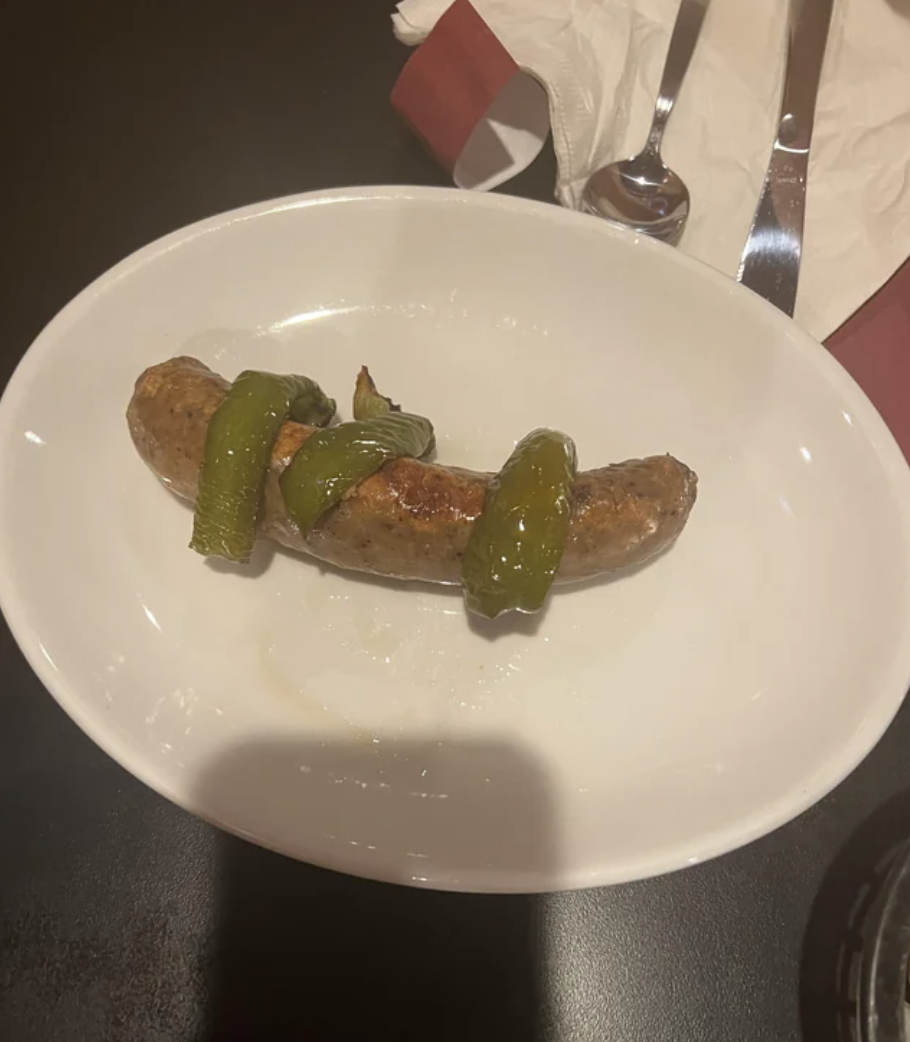 Limp peppers on a piece of sausage