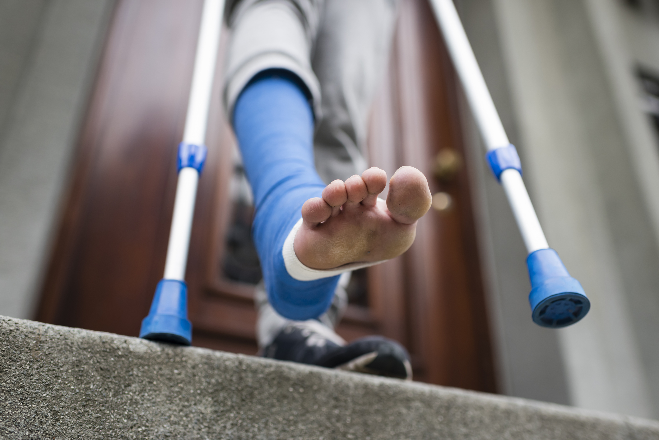 A person with a cast on their leg and using crutches