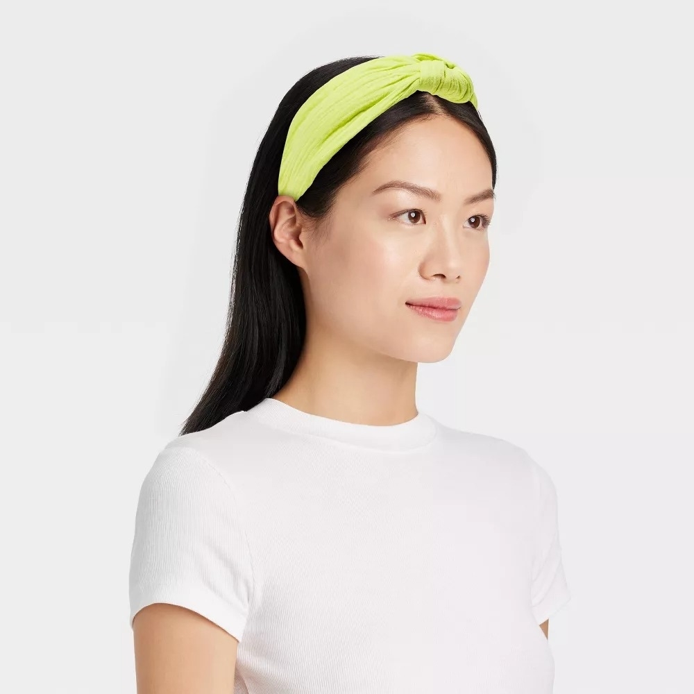 a model wearing the lime green muslin headband