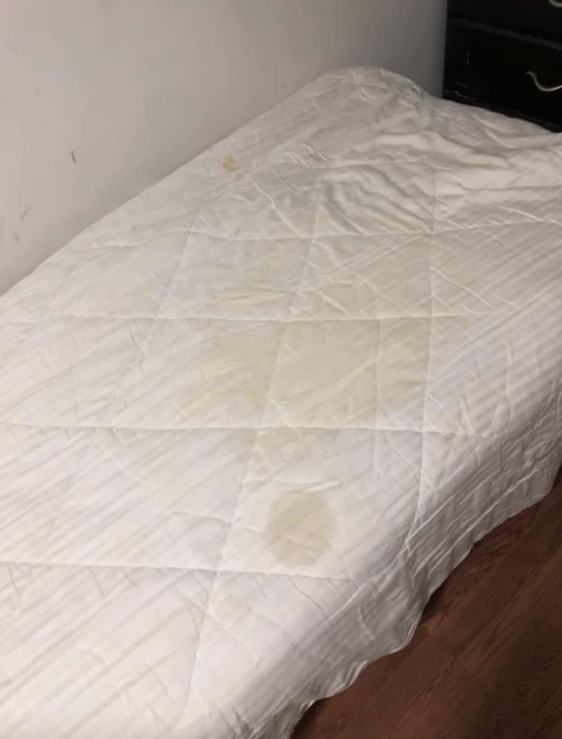 There are huge, gross-looking stains covering nearly half the bed