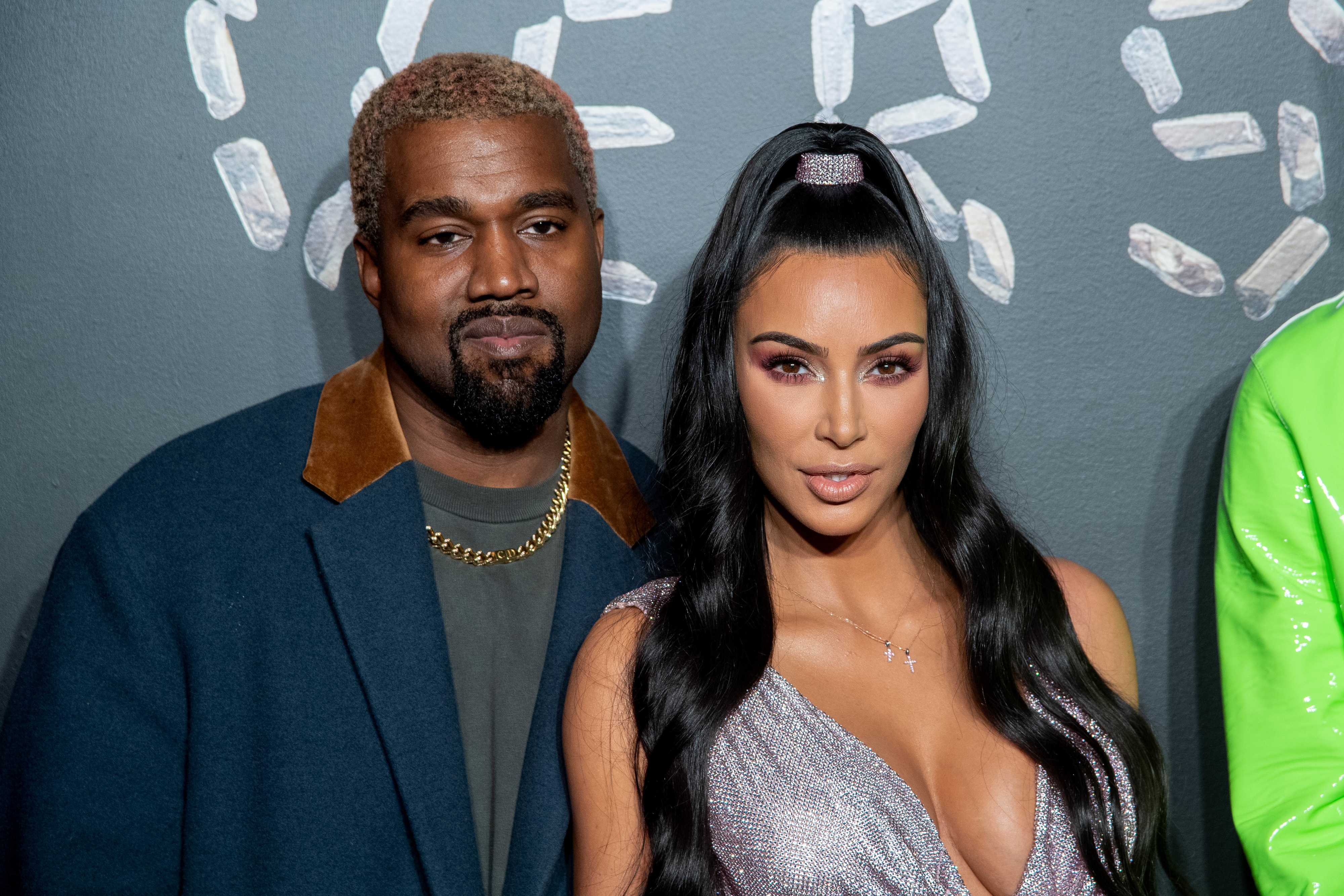 Close-up of Kim and Ye at a press event