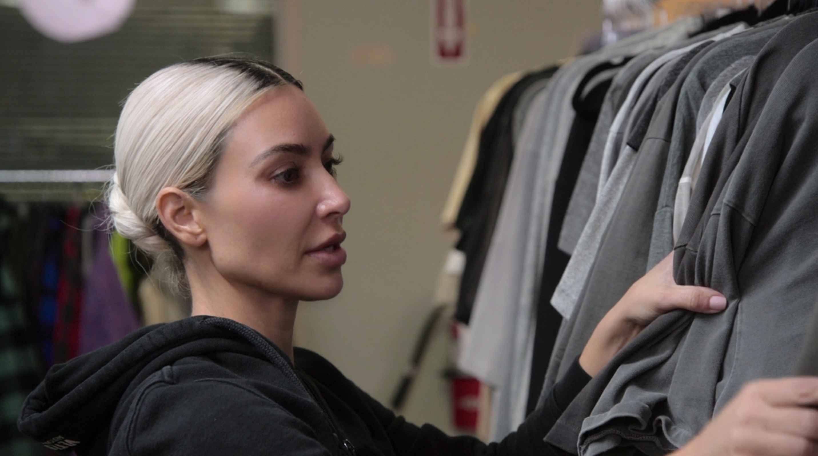 Close-up of Kim looking at the clothing