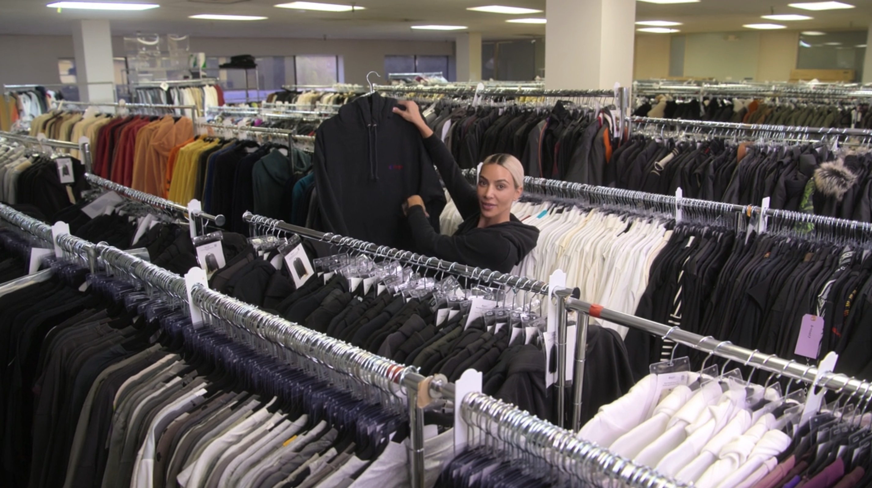 Kim amid the racks of clothing