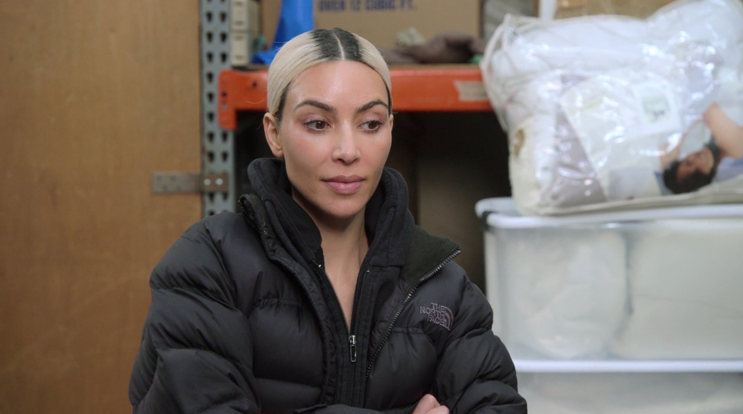Close-up of Kim amid the racks of clothing