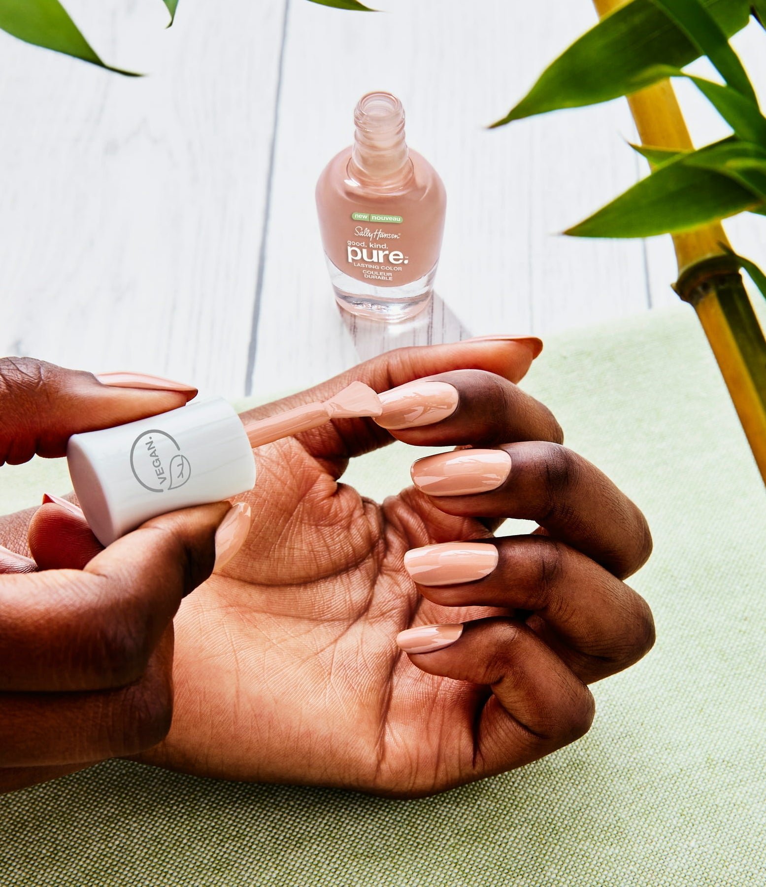 A model using a nude shade on their nails