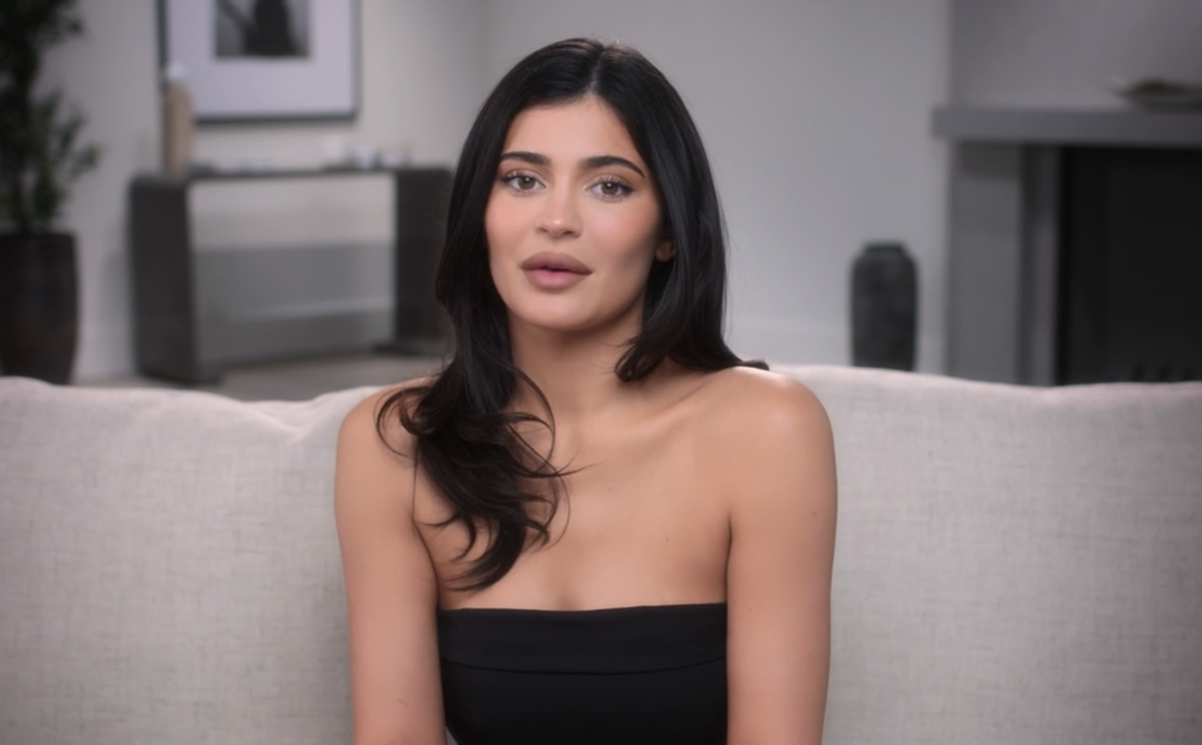 Close-up of Kylie sitting on a couch