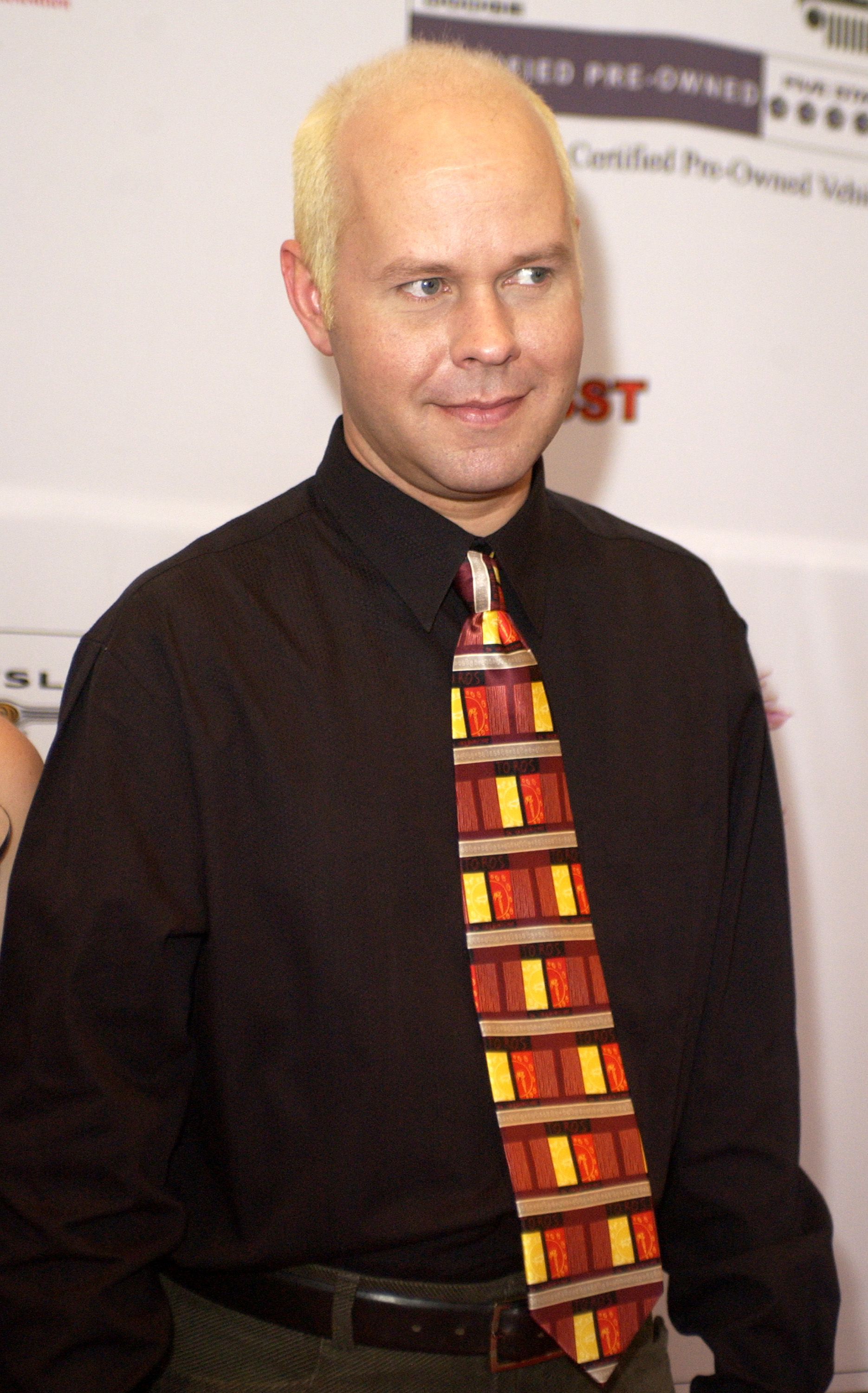 wearing a colorful tie with a dark button-down