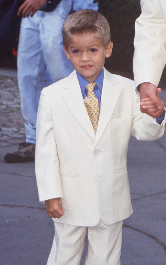 him as a little boy wearing a suit