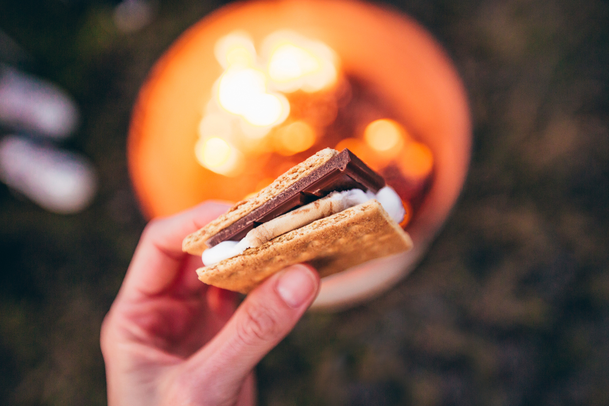 Holding s&#x27;more over a campfire.