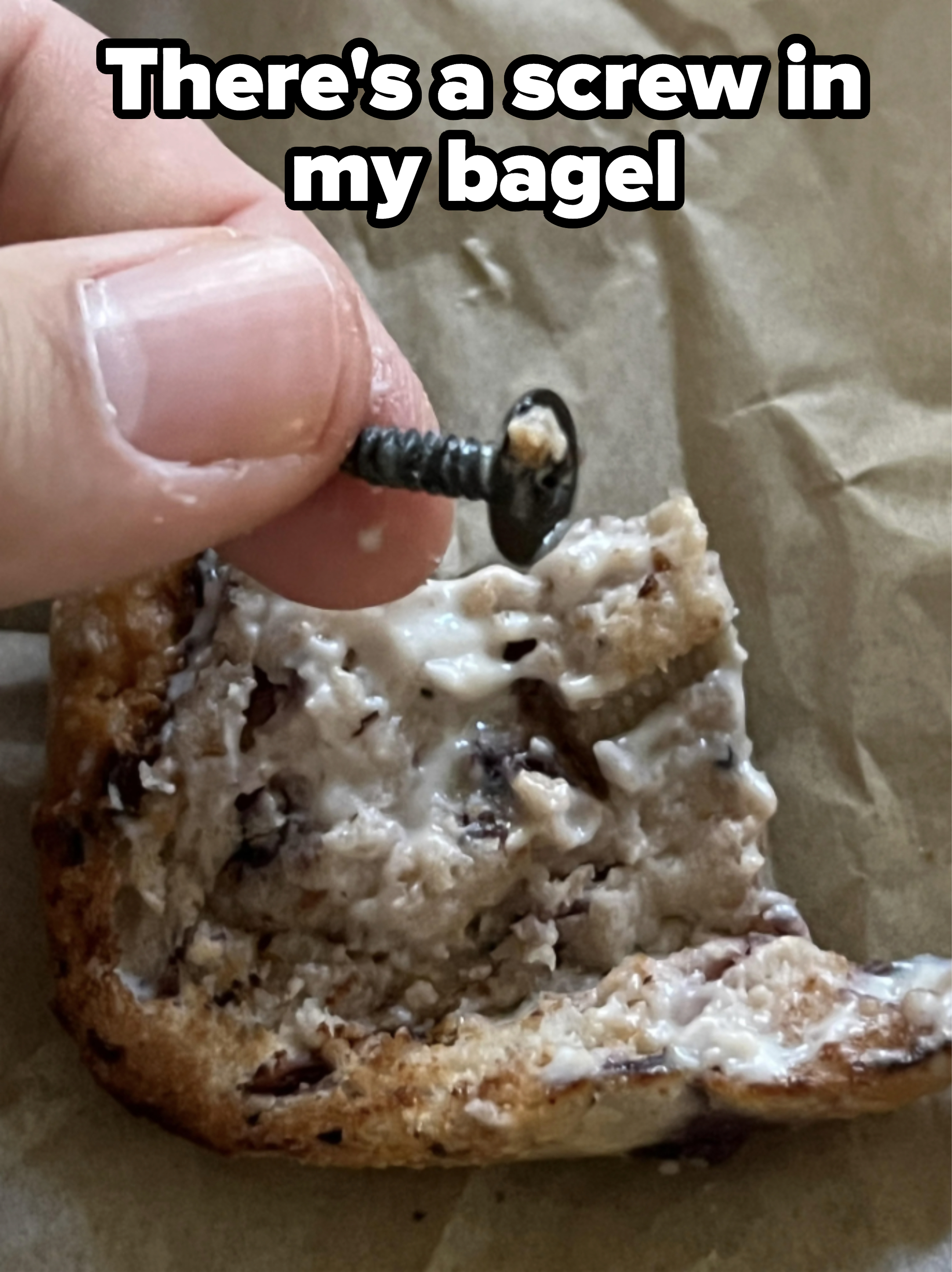 Close-up of a screw in a buttered bagel with the caption, &quot;There&#x27;s a screw in my bagel&quot;