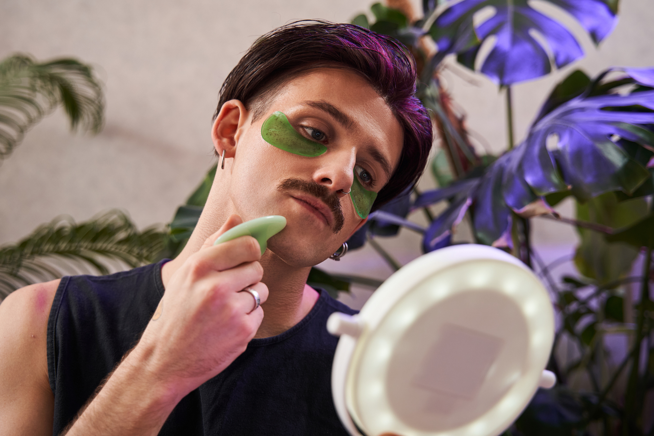 A person using gua sha tools on their face