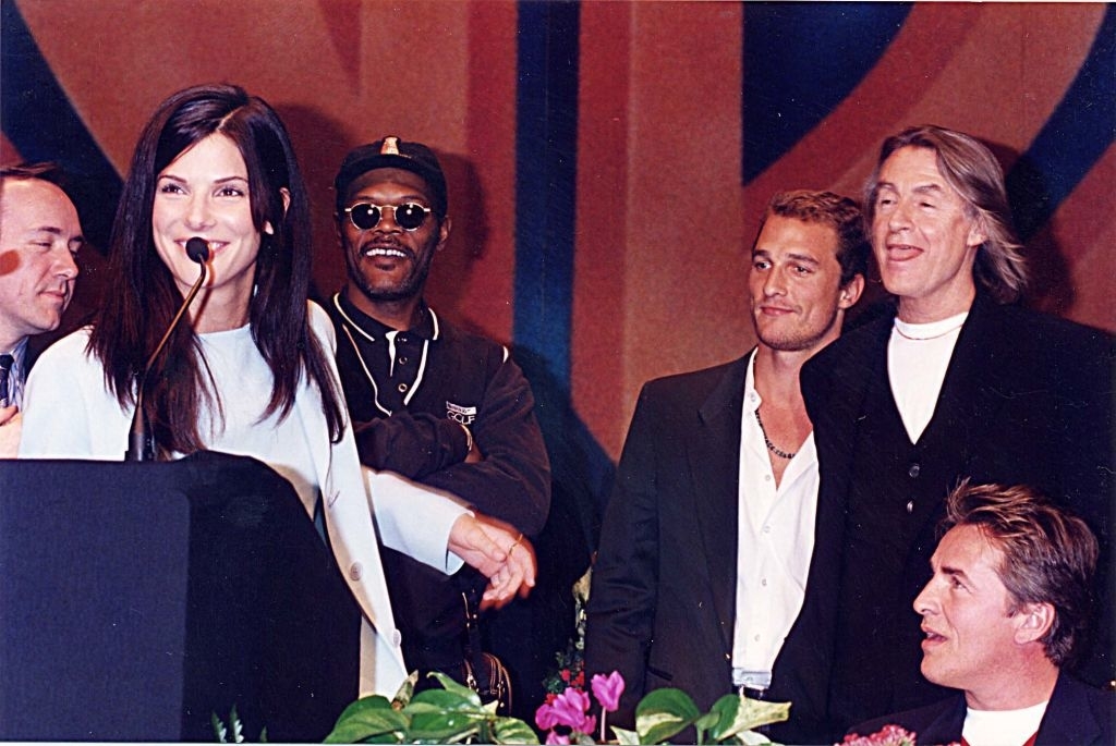 cast of the movie on stage with sandra talking into a mic