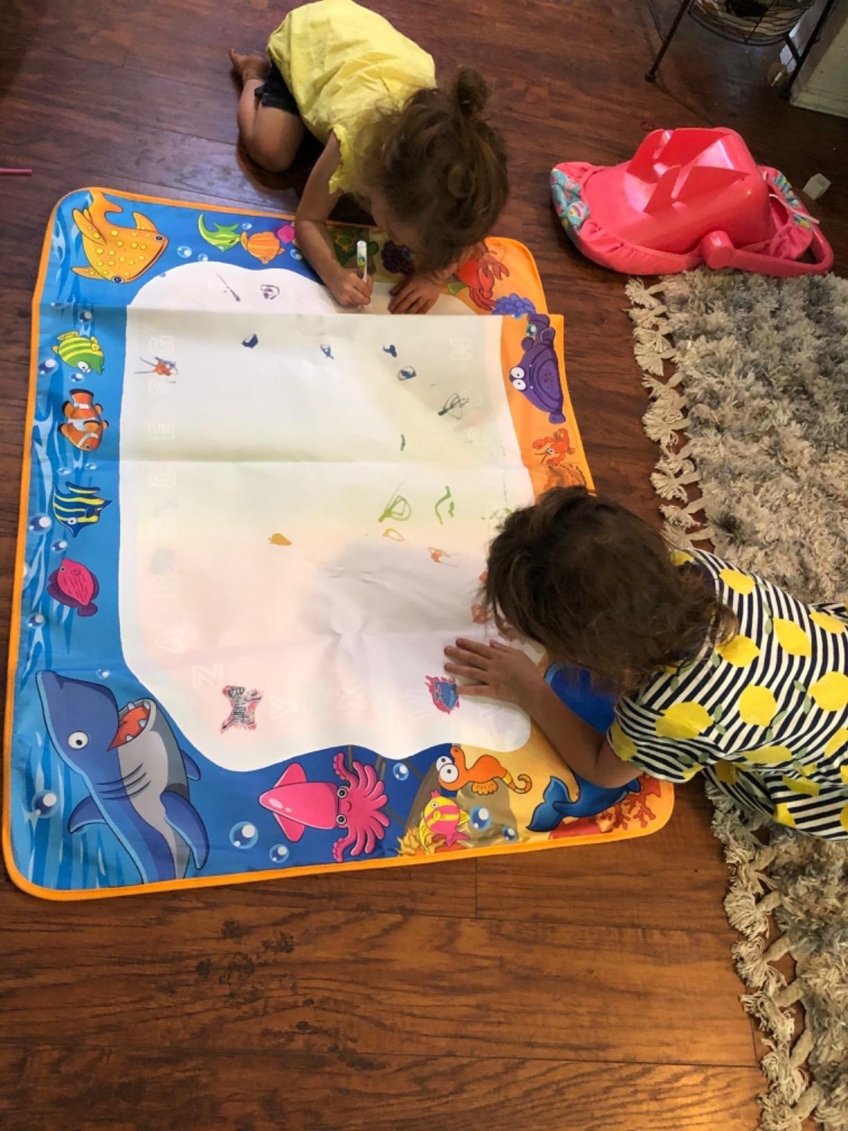 Reviewer photo of kids drawing on a water mat