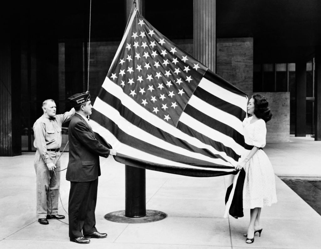 People raising the American flag