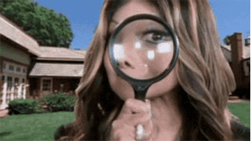 GIF of a woman with a magnifying glass