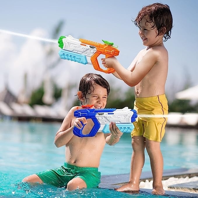 Two kids play with water blasters