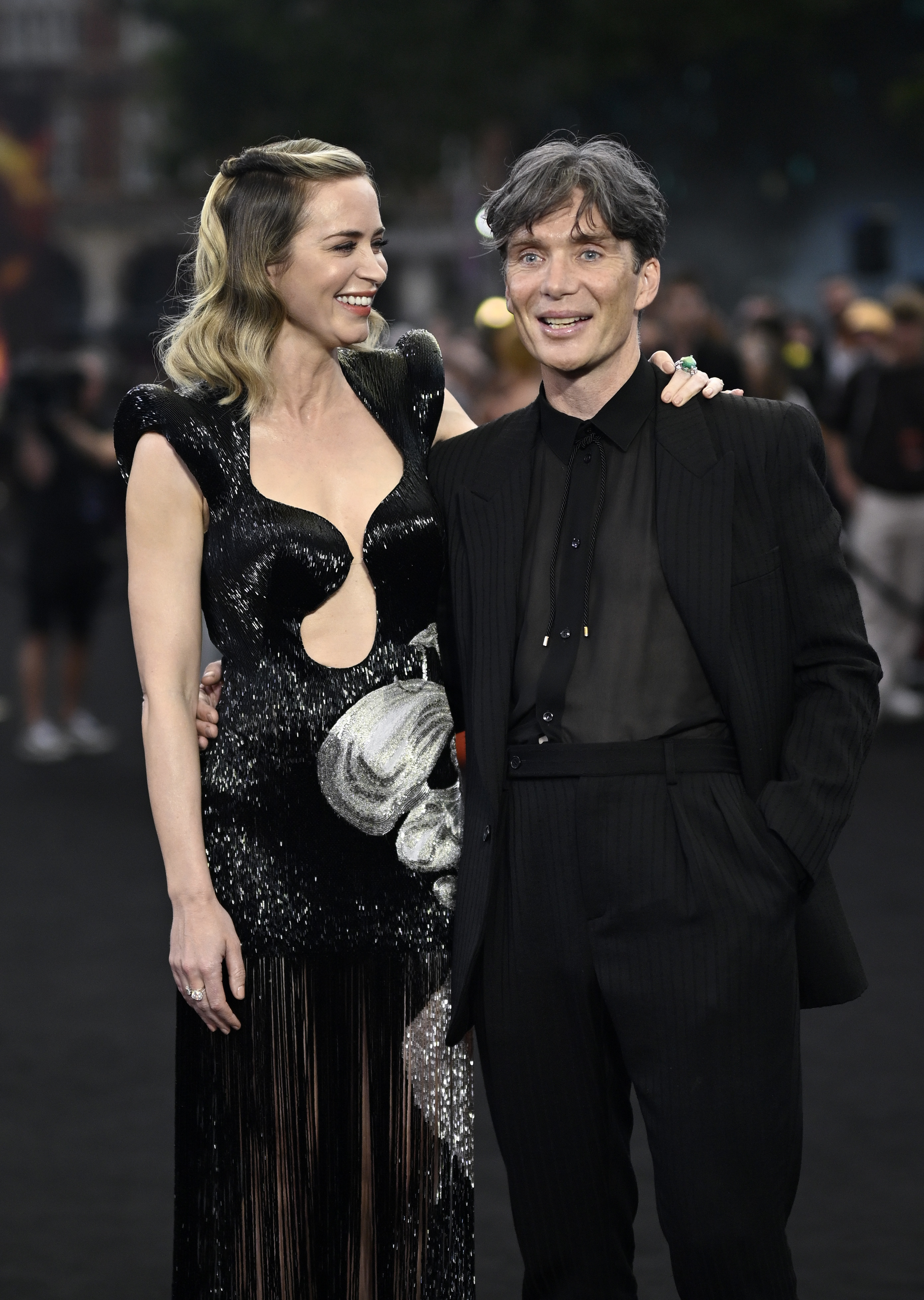 Emily and Cillian, who play husband and wife in Oppenheimer, smile at the premiere