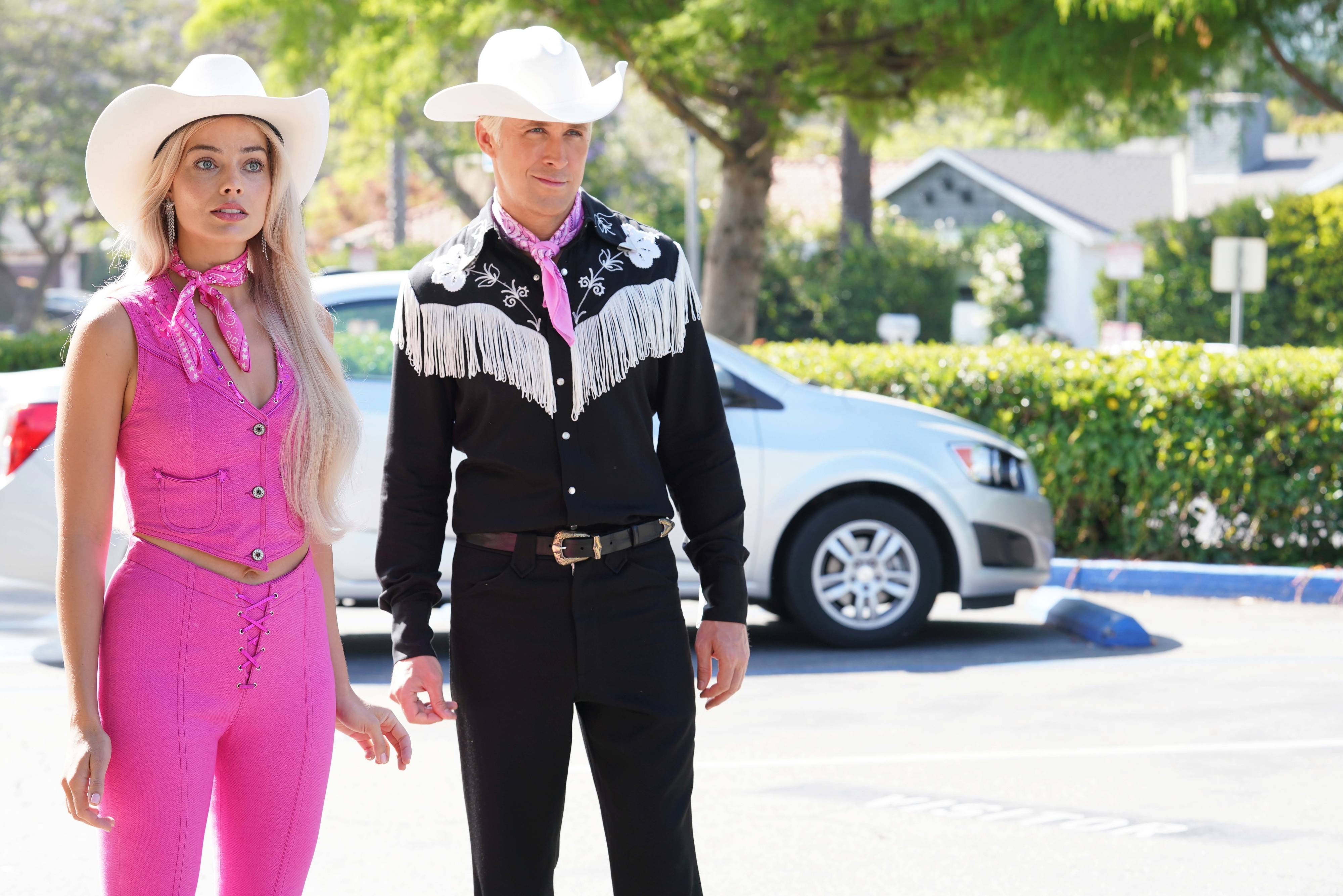 Margot and Ryan as Barbie and Ken dressed in western themed outfits including cowboy hats