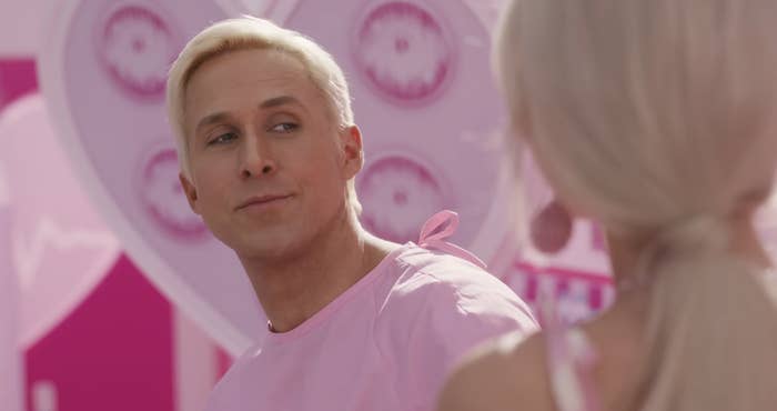 Ryan as Ken looking at Margot as Barbie