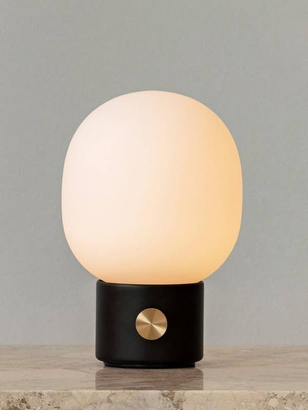 round table lamp with a short, small black base with a dial