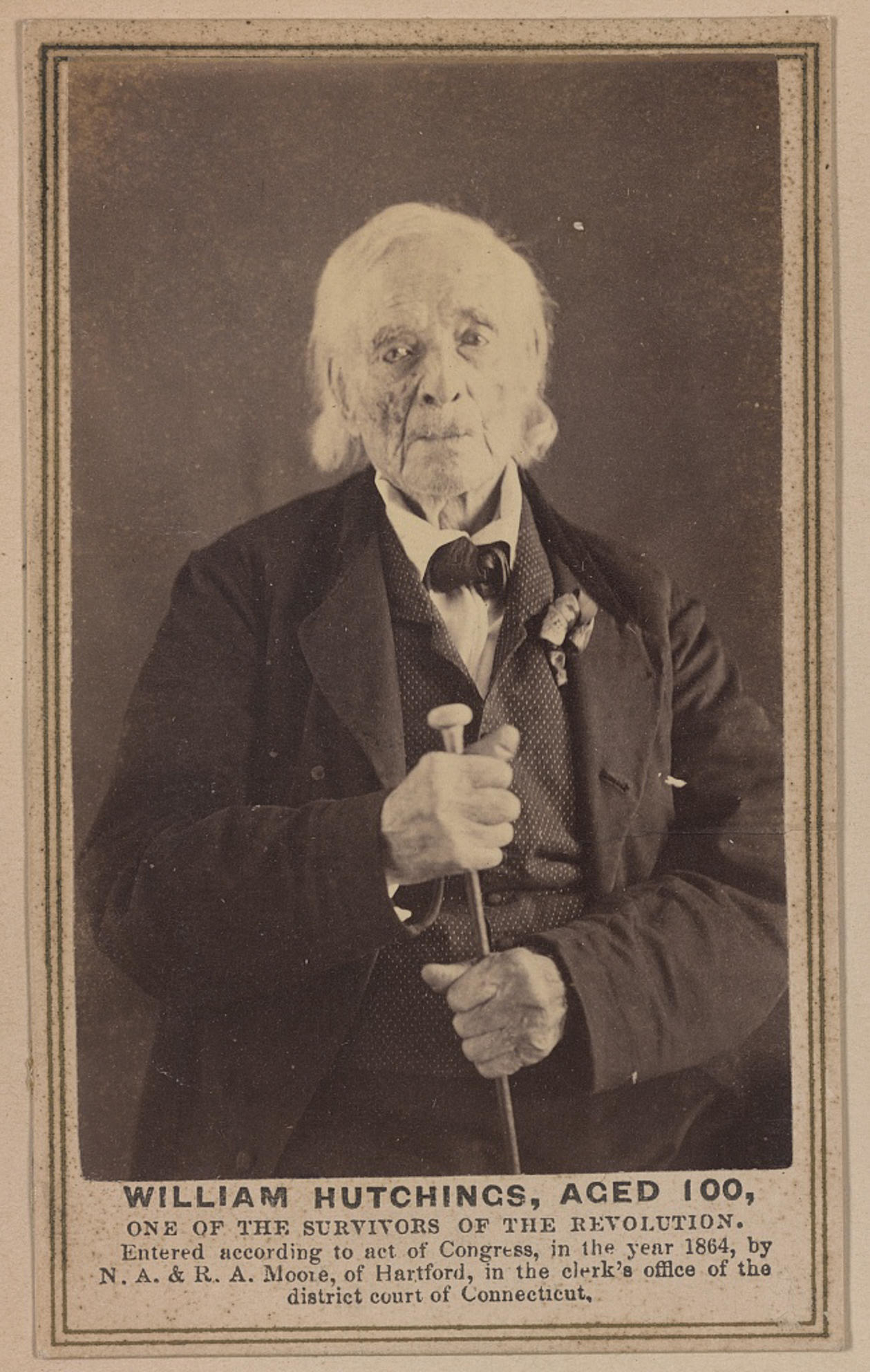 He&#x27;s 100 in the portrait and looks very old, with some white, longish hair and wearing a suit, vest, and bow tie, with caption &quot;William Hutchings, aged 100, one of the survivors of the revolution; entered according to act of Congress in the year 1864&quot;
