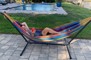 Reviewer sitting in hammock by pool