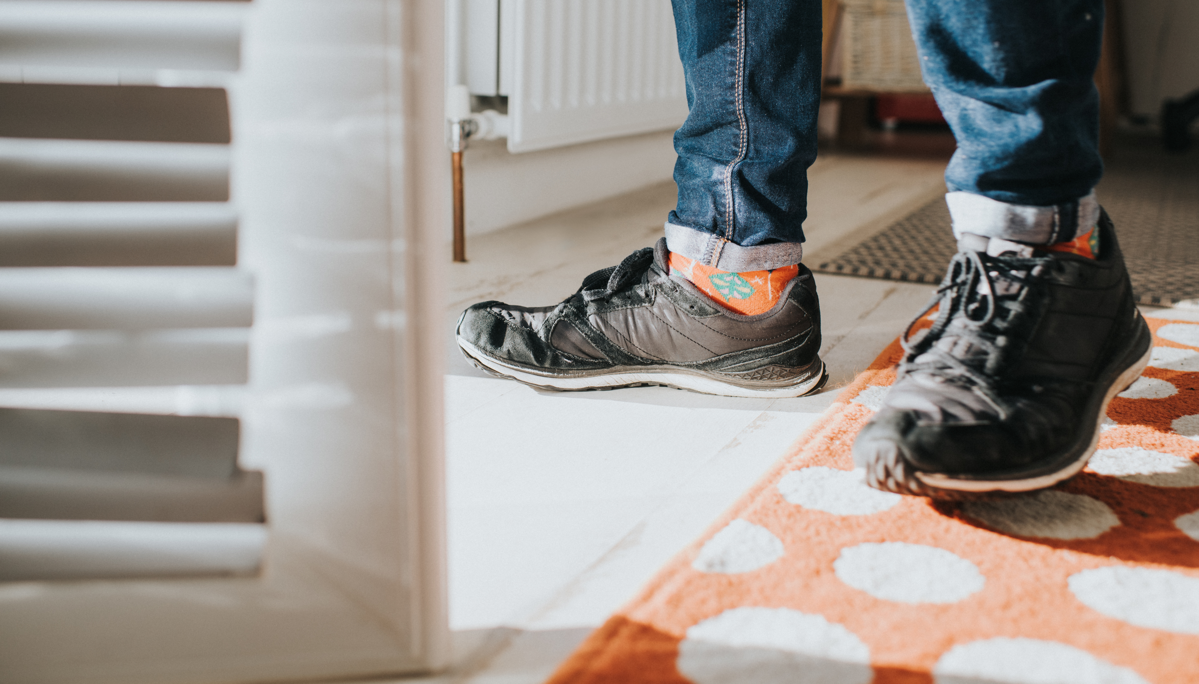 a pair of sneakers walking inside a house