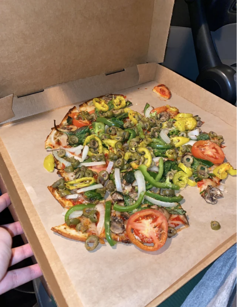 mess of a pizza in its box