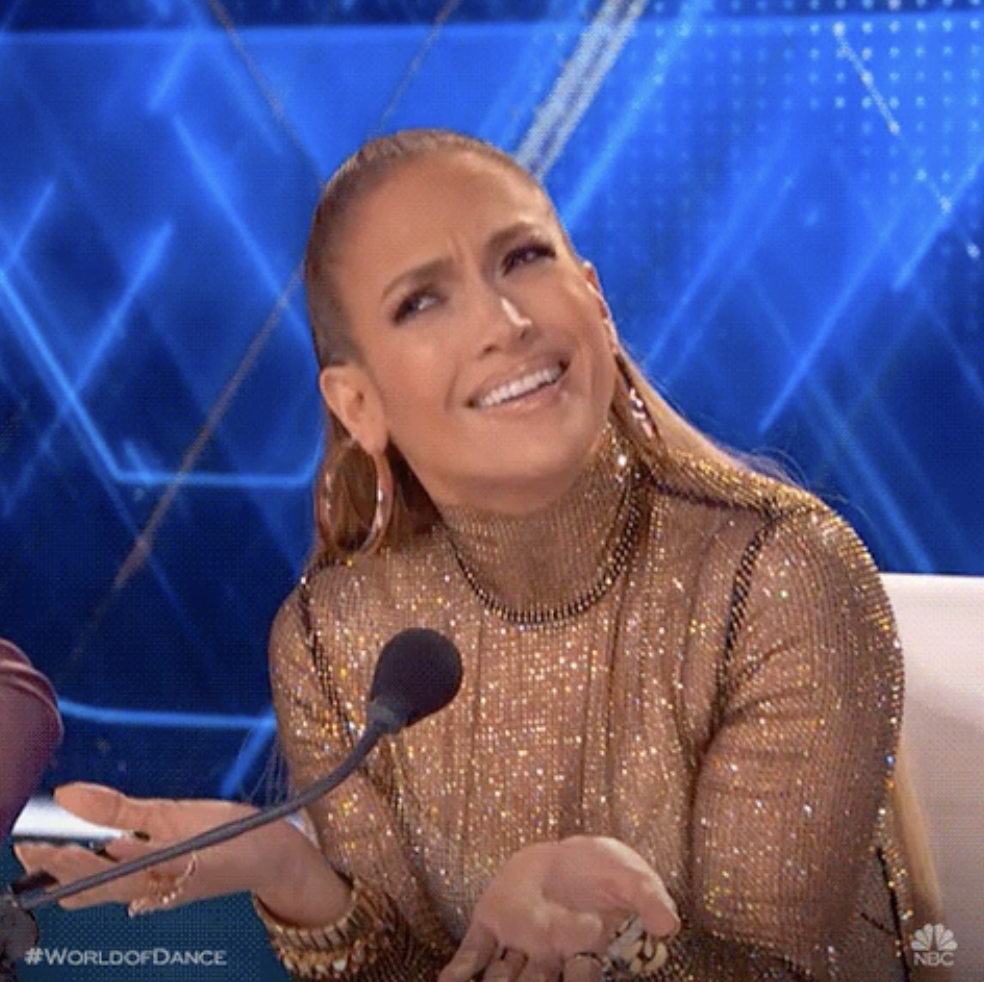 J.Lo with her hands open and making a face of confusion
