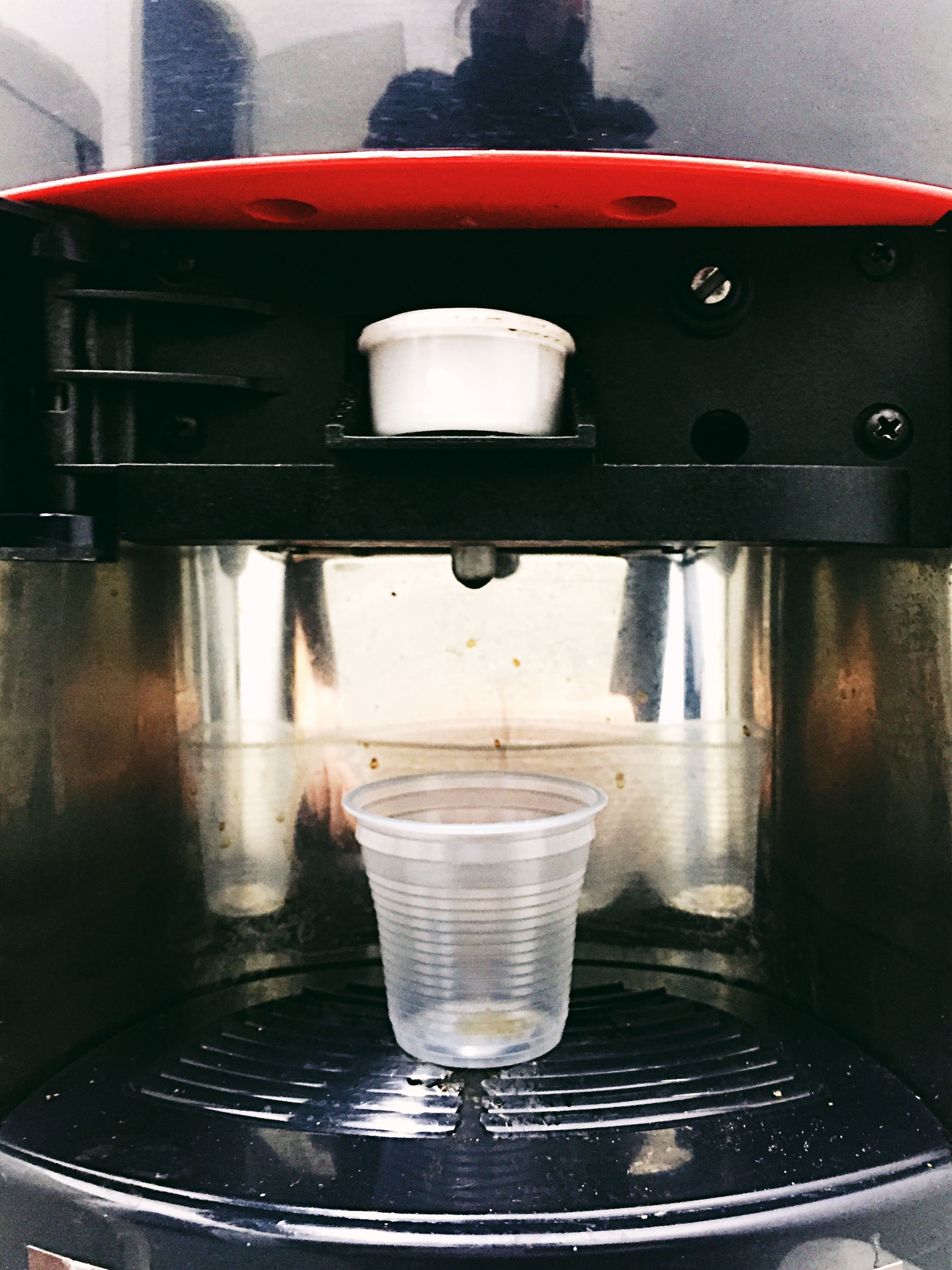 A little cup in a coffee maker