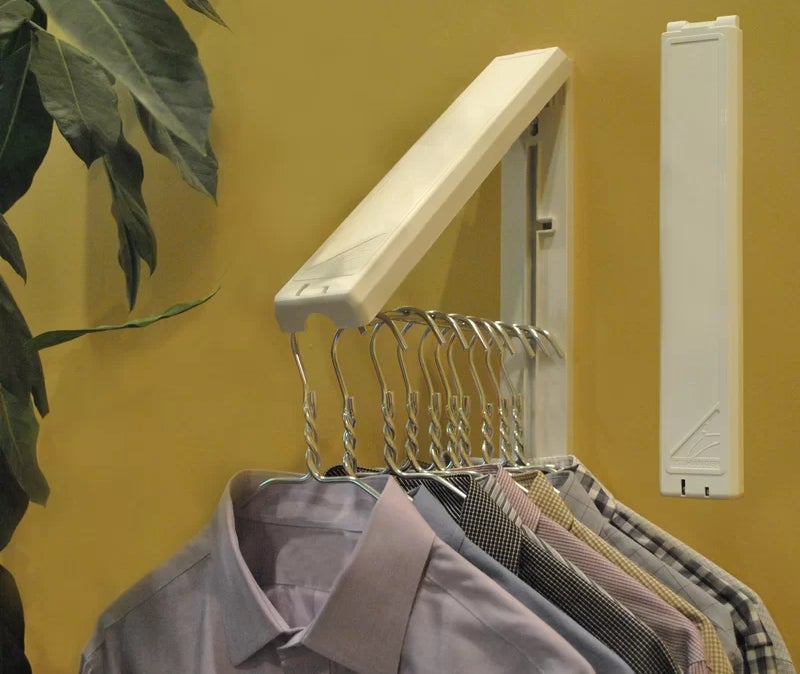 the open rack mounted on a wall holding collared shirts