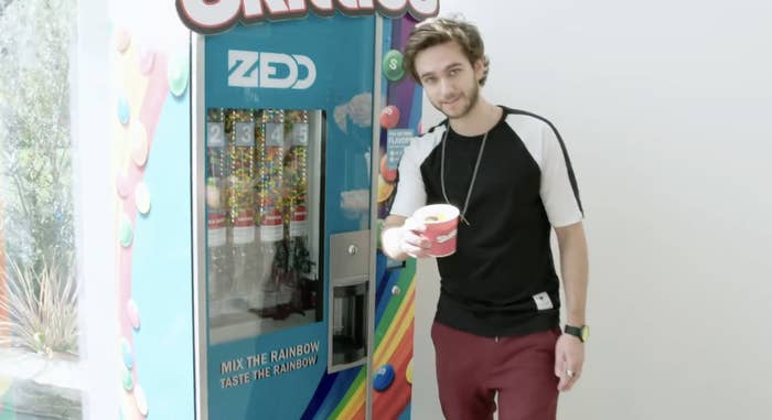 Zedd with his Skittles dispenser in his house