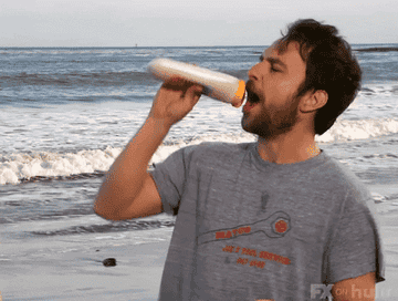 Charlie from It&#x27;s Always Sunny pouring sunscreen into his mouth on the beach