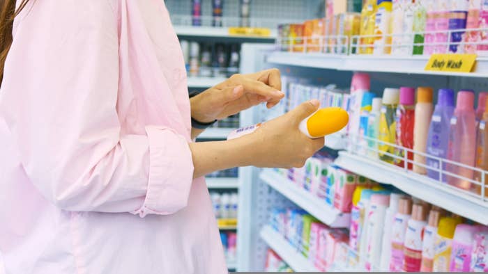 woman shopping in the skin care aisle of a pharmacy
