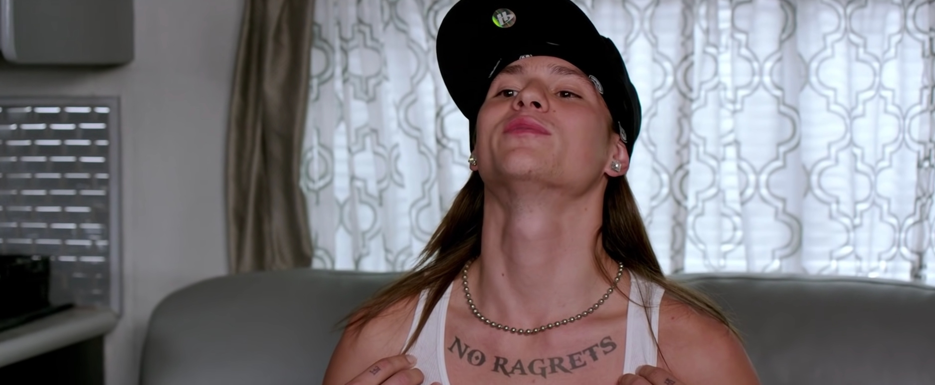 A man with a tattoo that says &quot;No ragrets&quot;