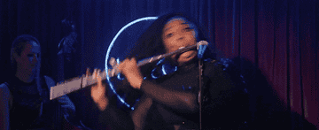 Lizzo playing the flute on stage