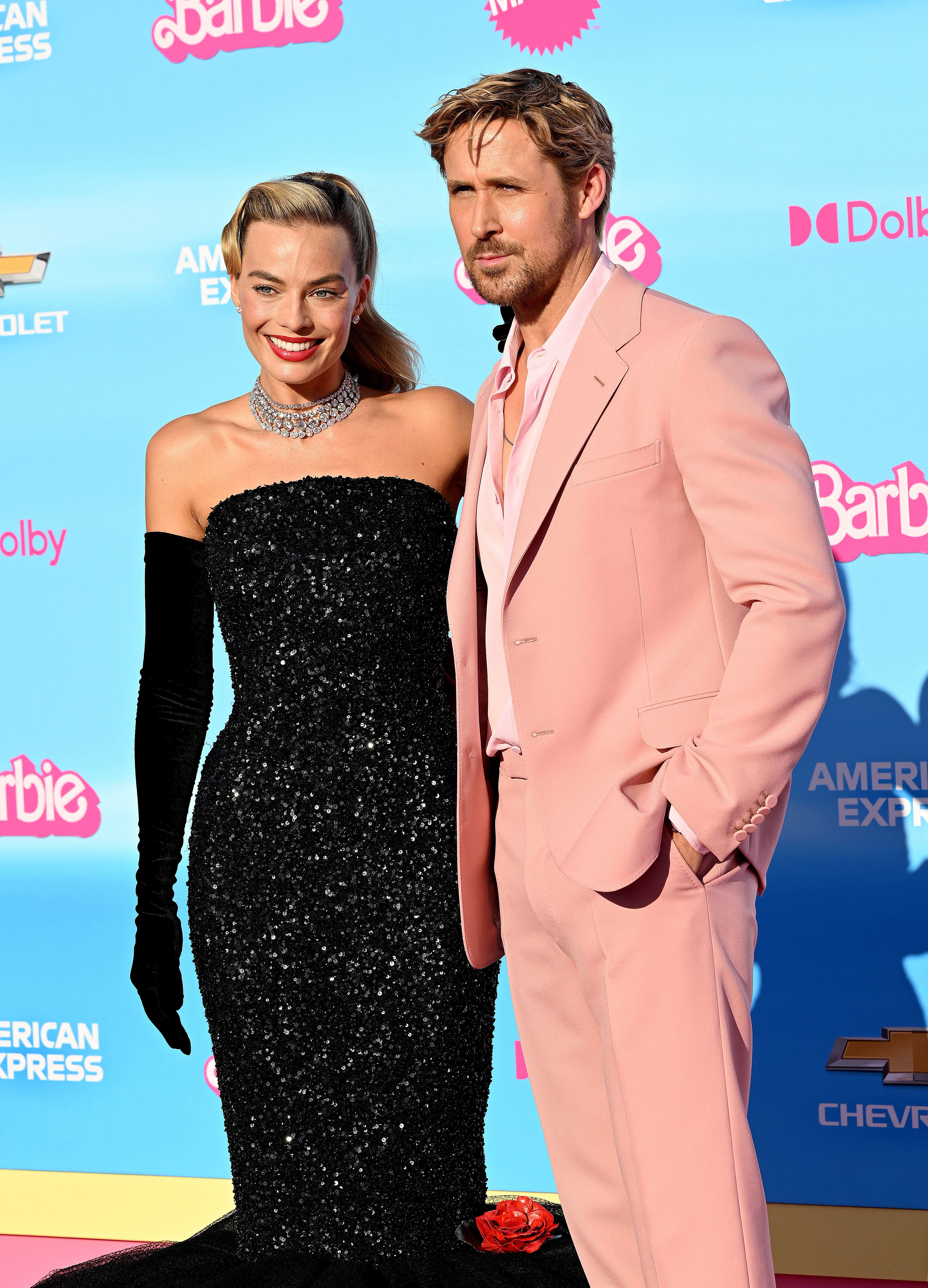 margot and ryan posing on the pink carpet