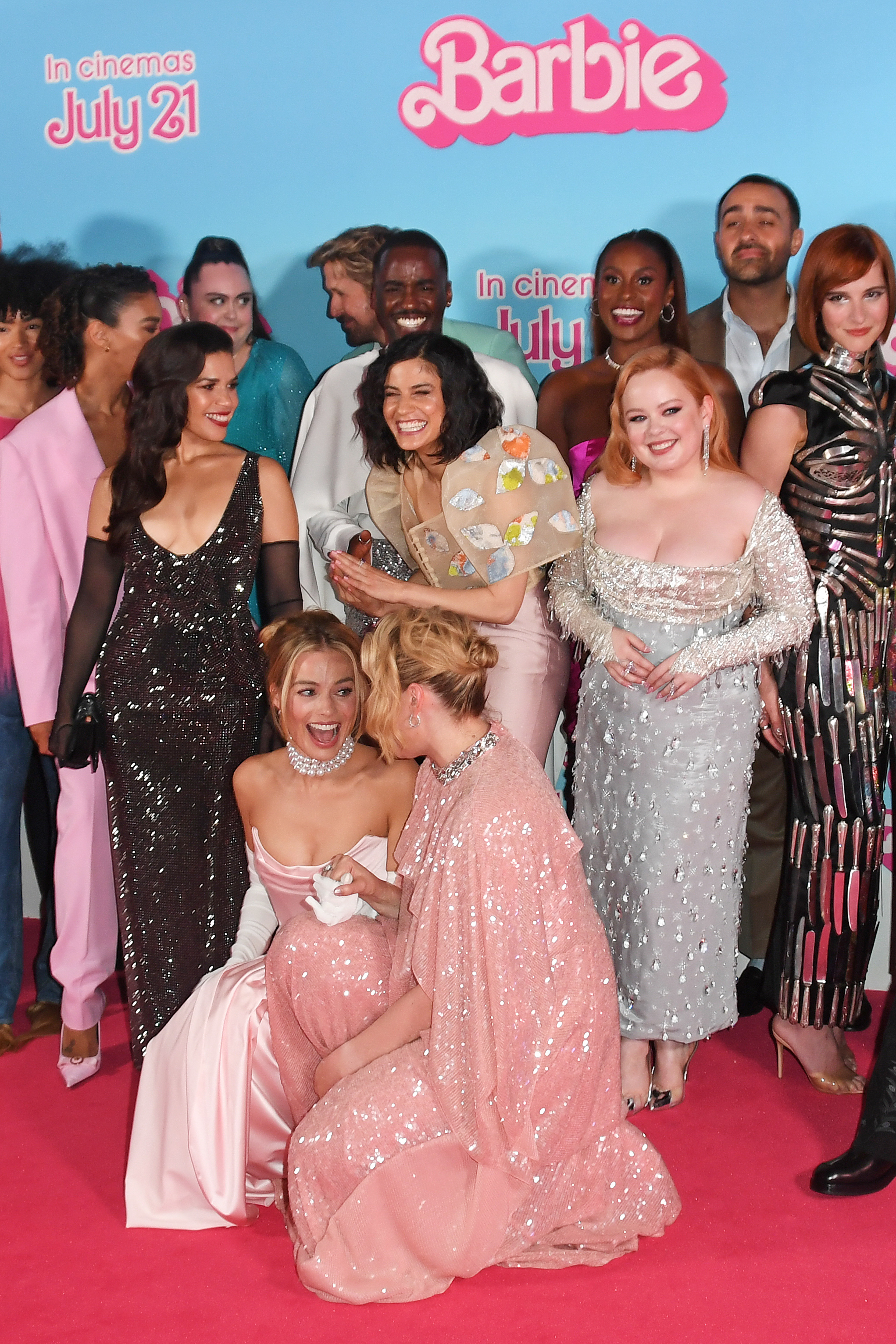 the cast squeezing in for a photo on the red carpet