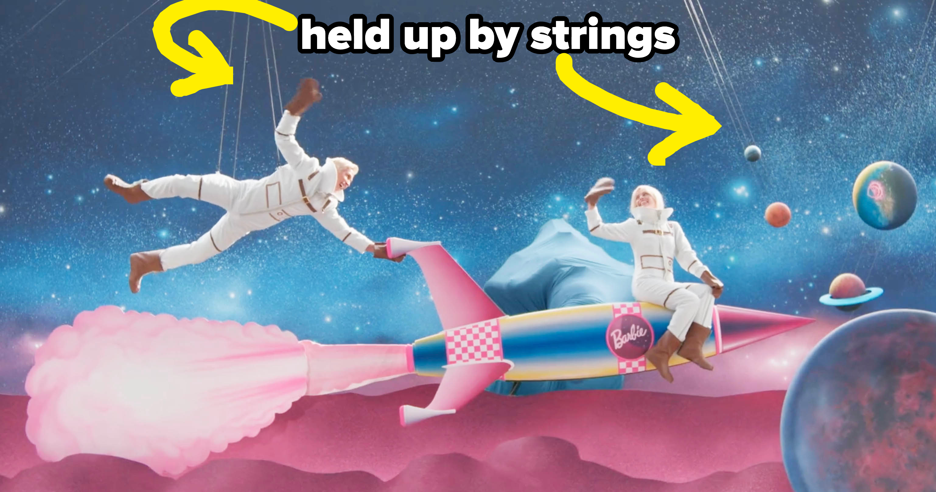 Ryan and planets being held up by strings during the space sequence