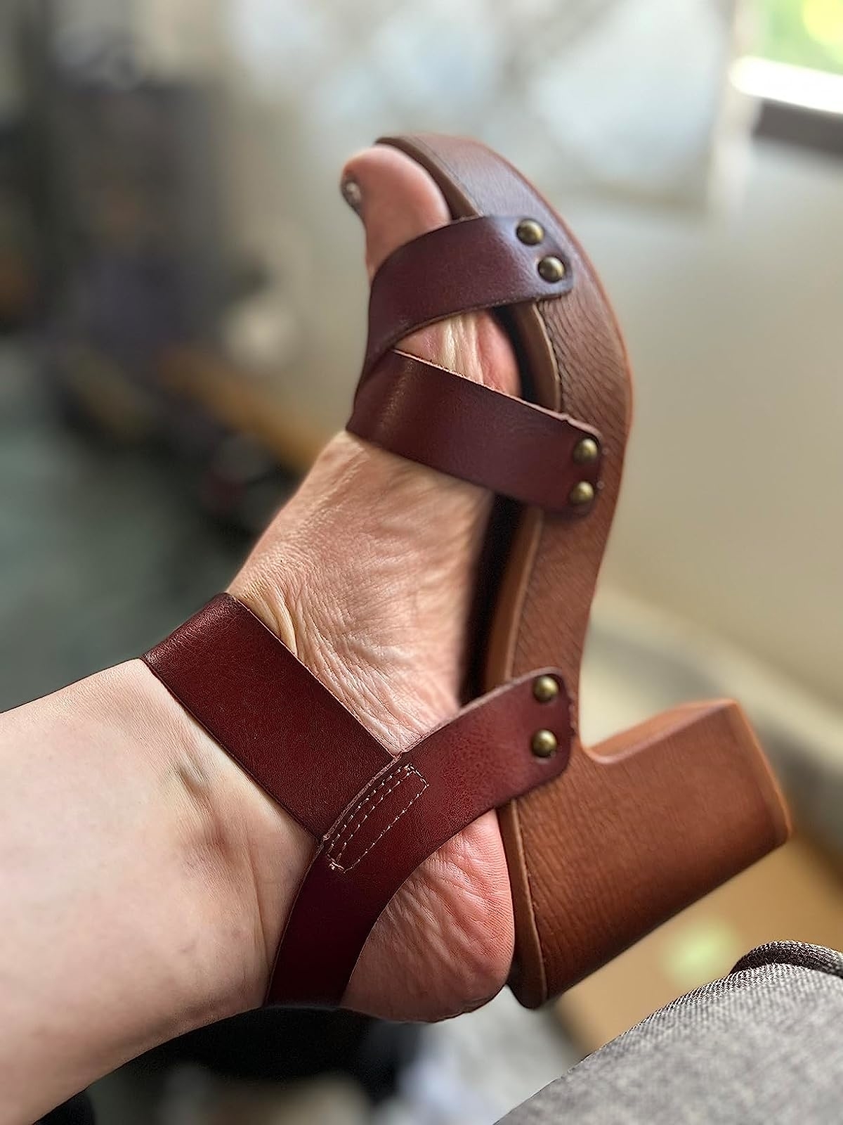 a reviewer showing off brown shoe