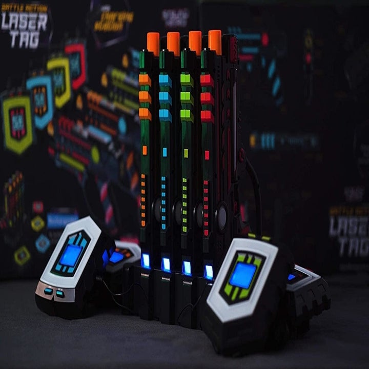 Laser Tag blasters stood upright in their charging stations