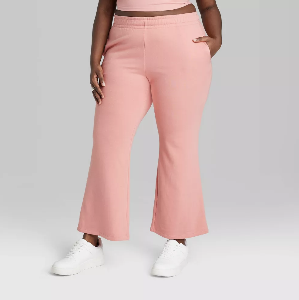 Model in Women&#x27;s High-Rise Wide Leg French Terry Sweatpants - Wild Fable™ in coral pink
